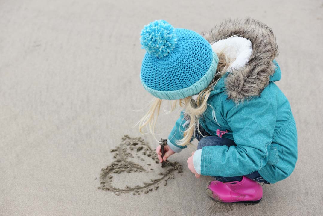 Drawing hearts in the sand is a great way to spend time in Mornington Peninsula